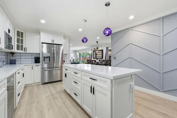a kitchen with cabinets and stainless steel appliances