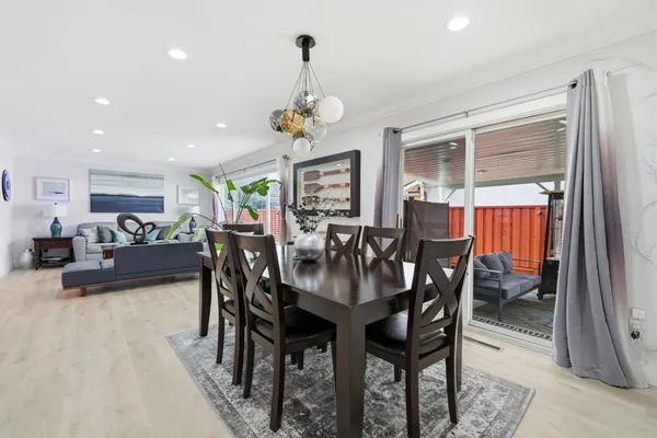 a view of a dining room with furniture wooden floor and chandelier