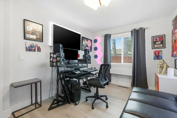 a view of a workspace with furniture and a window