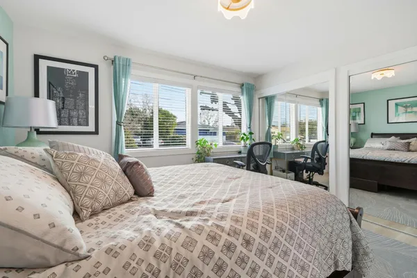 a bedroom with a large bed and a large window