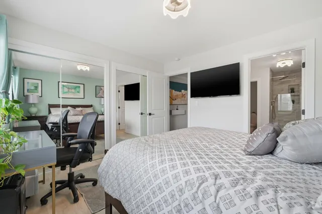 a bedroom with a bed and a flat screen tv