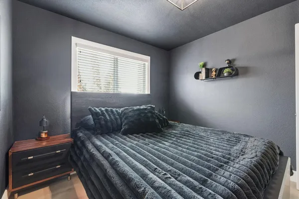 a bedroom with a bed and window