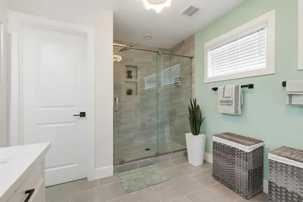 a bathroom with a shower and a sink