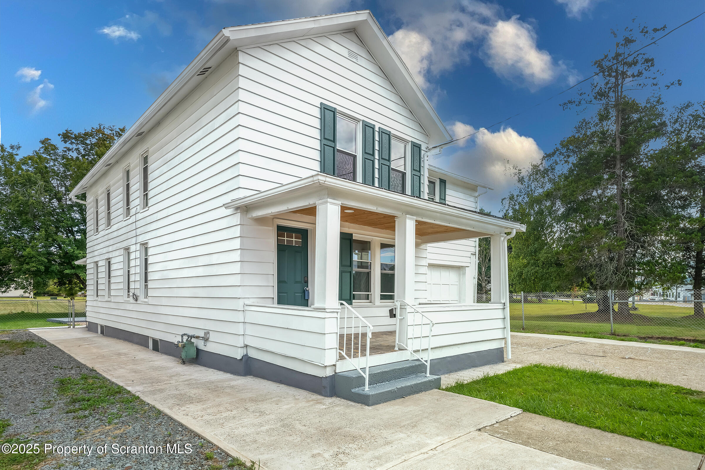 1017 Rutter Avenue Kingston, PA 18704 - Photo 2 of 36 a view of a white house with a yard and plants