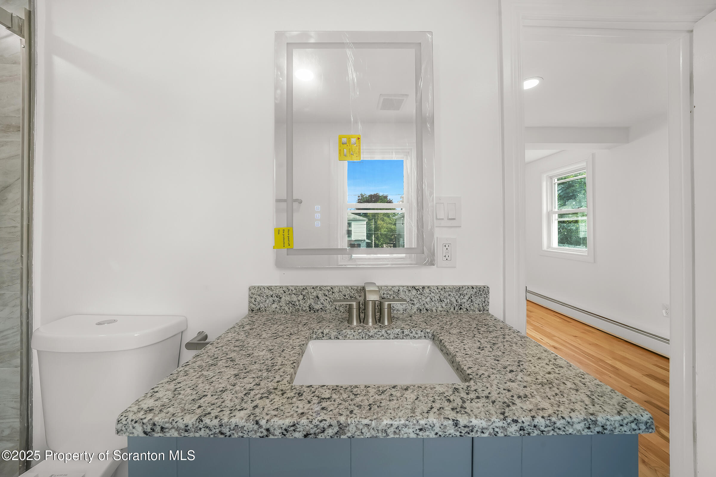 1017 Rutter Avenue Kingston, PA 18704 - Photo 21 of 36 a bathroom with a granite countertop sink and a mirror