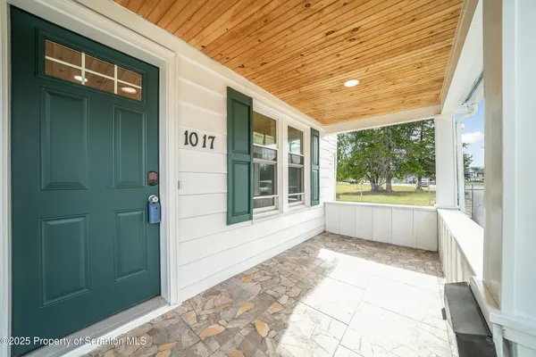 a front view of a house with a large window