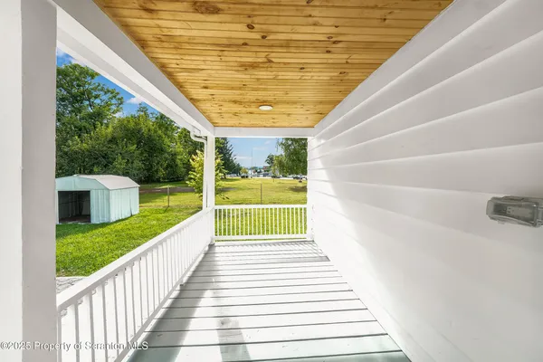 a view of a patio with wooden floor