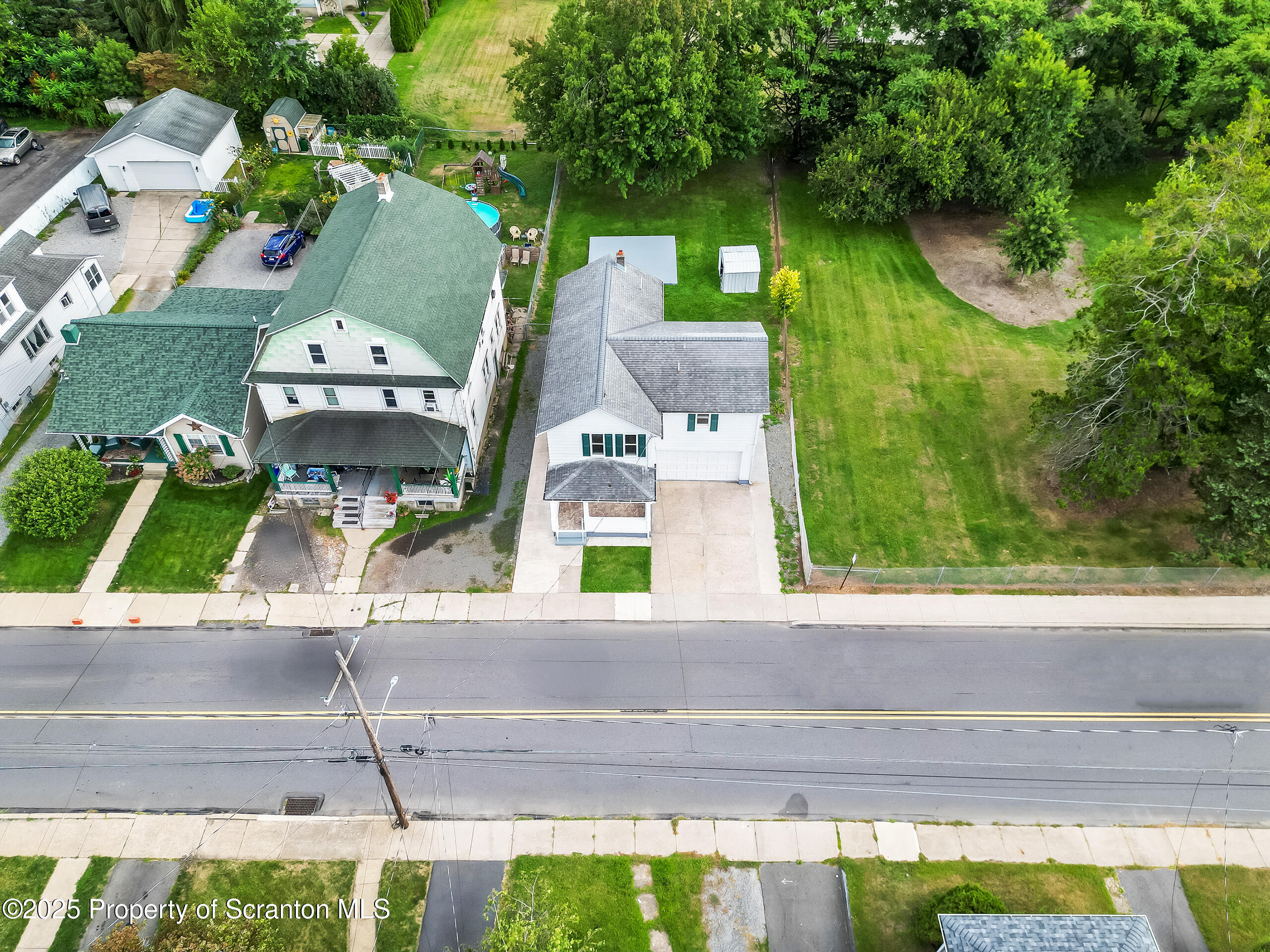 1017 Rutter Avenue Kingston, PA 18704 - Photo 9 of 36 an aerial view of a house with a yard and large trees