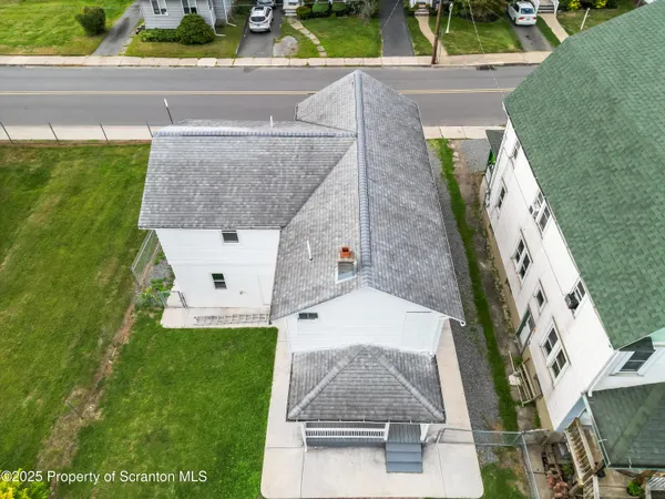 an aerial view of a house with a yard