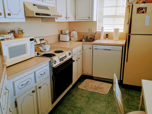 a kitchen with a stove top oven sink and cabinets