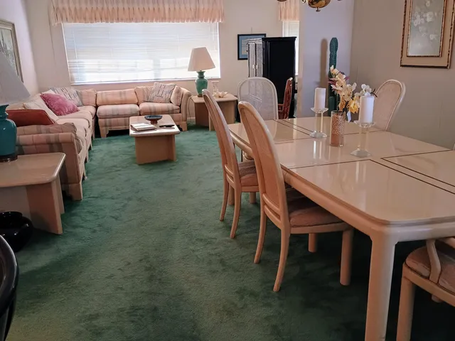 a dining room with furniture and a chandelier