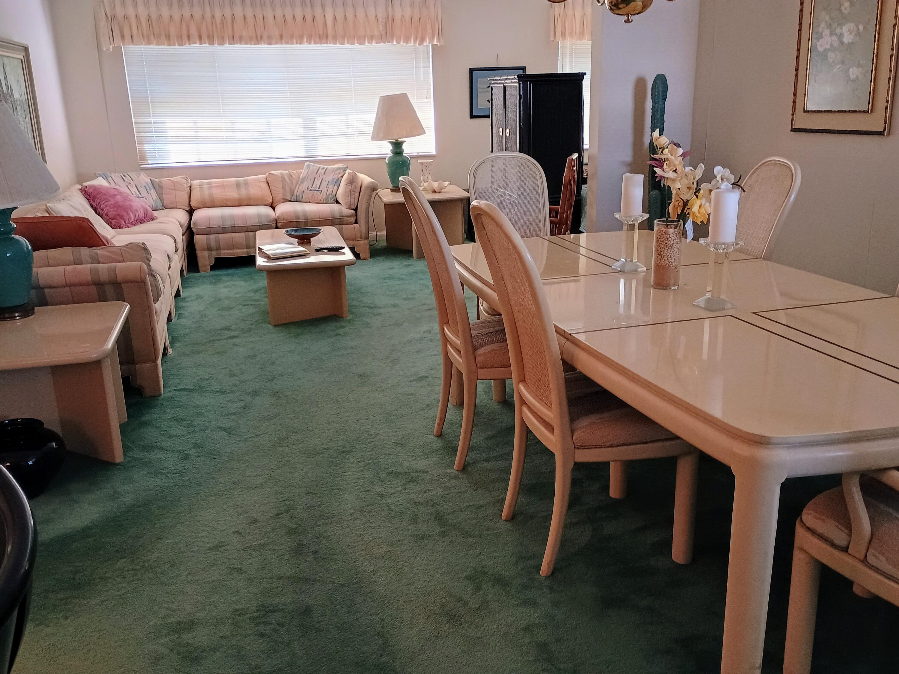 5505 North Ocean Boulevard, Unit 6206 Ocean Ridge, FL 33435 - Photo 14 of 25 a dining room with furniture and a chandelier