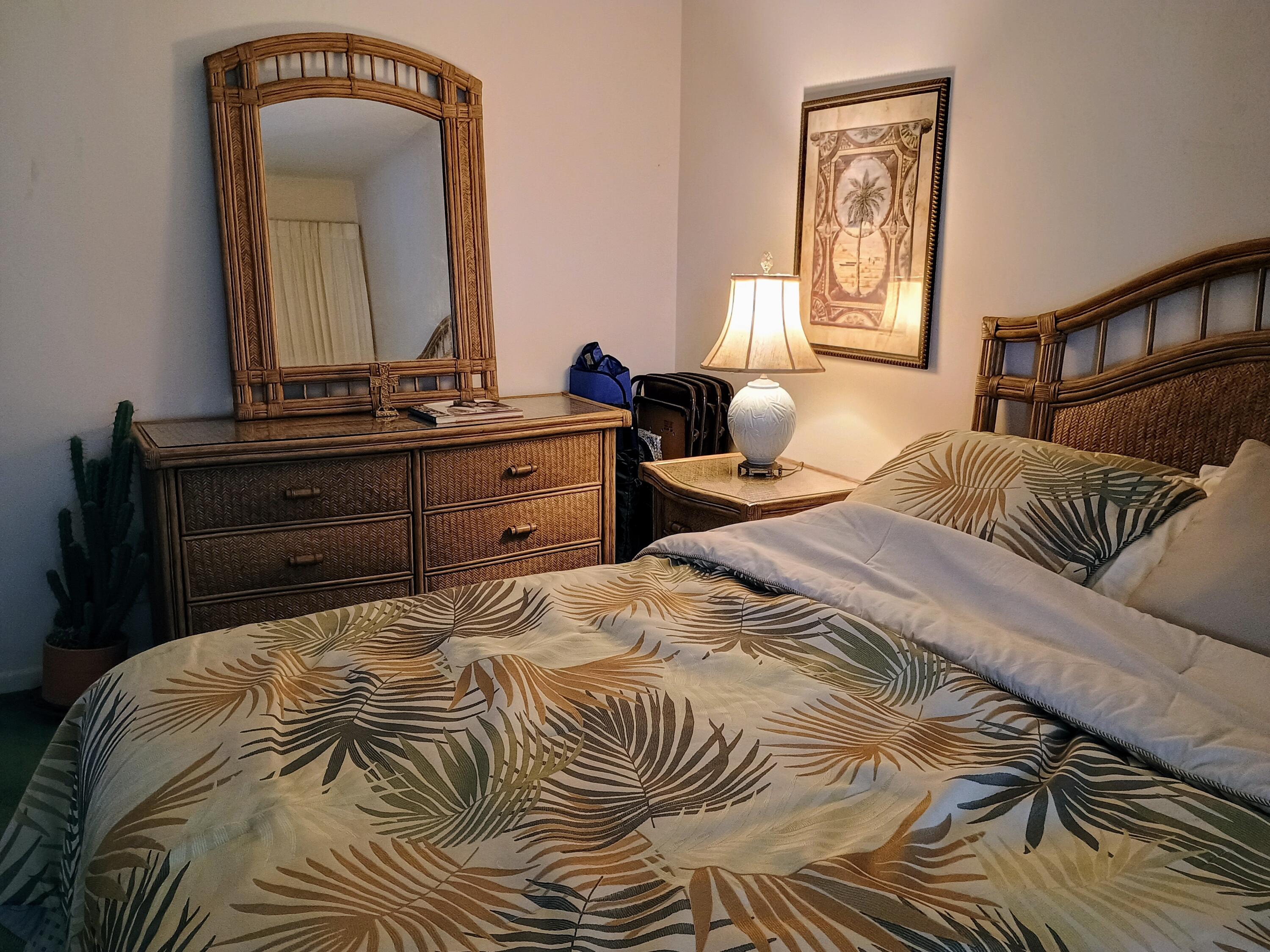 5505 North Ocean Boulevard, Unit 6206 Ocean Ridge, FL 33435 - Photo 18 of 25 a bedroom with a bed and a mirror on dresser