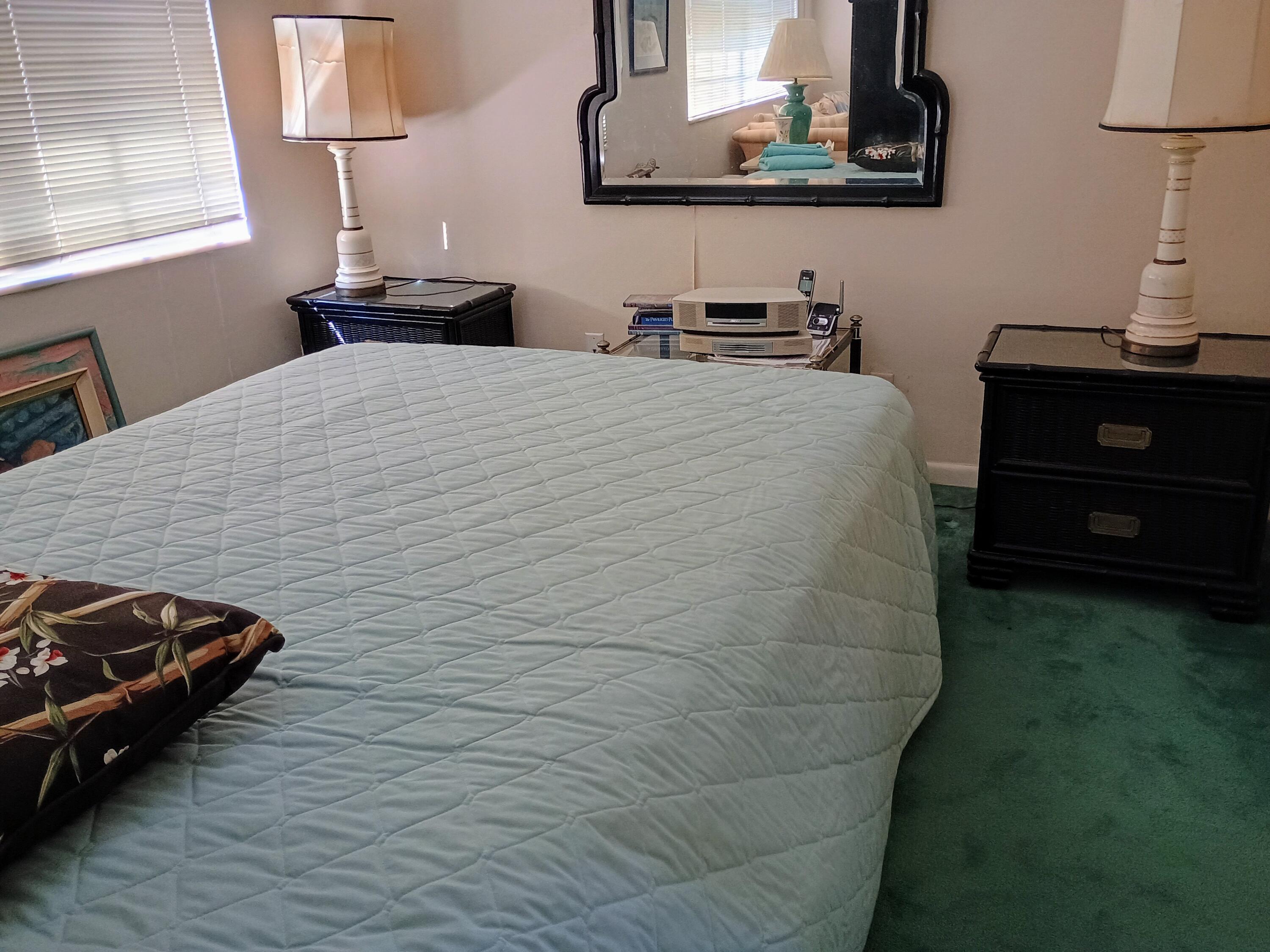 5505 North Ocean Boulevard, Unit 6206 Ocean Ridge, FL 33435 - Photo 23 of 25 a bedroom with a bed and a lamp on dresser