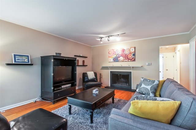 1138 Dell Road Northbrook, IL 60062 - Photo 3 of 16 a living room with furniture a flat screen tv and a fireplace