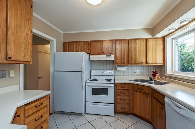 1138 Dell Road Northbrook, IL 60062 - Photo 5 of 16 a kitchen with a sink a stove a refrigerator and a window
