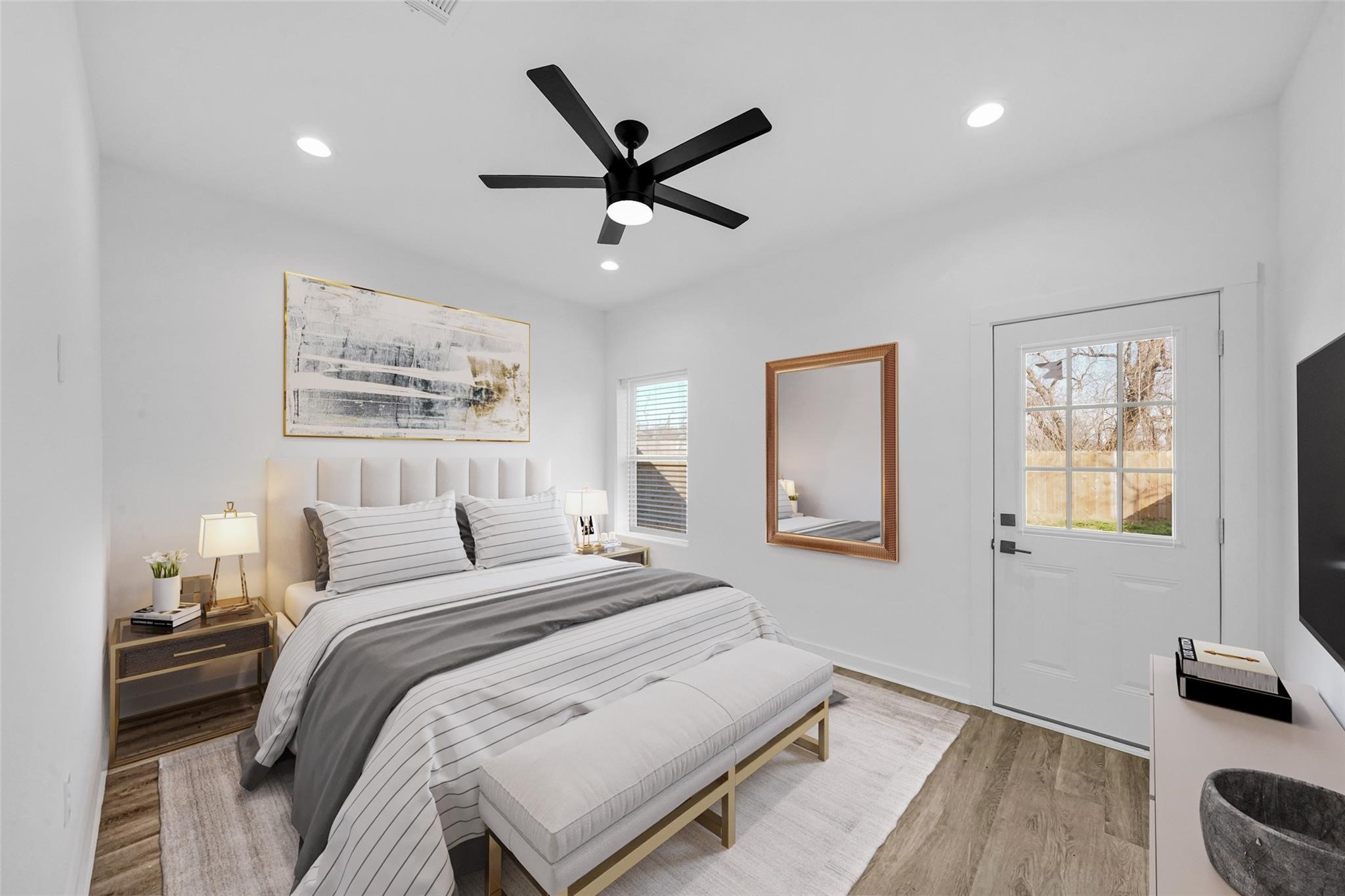 8402 Double, Unit B Houston, TX 77088 - Photo 12 of 21 a bedroom with a large bed and a ceiling fan