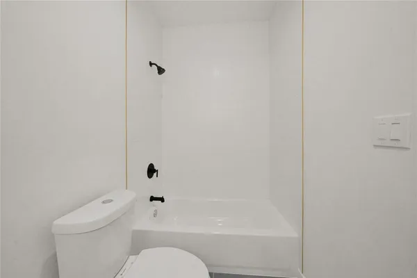 a bathroom with a toilet and shower