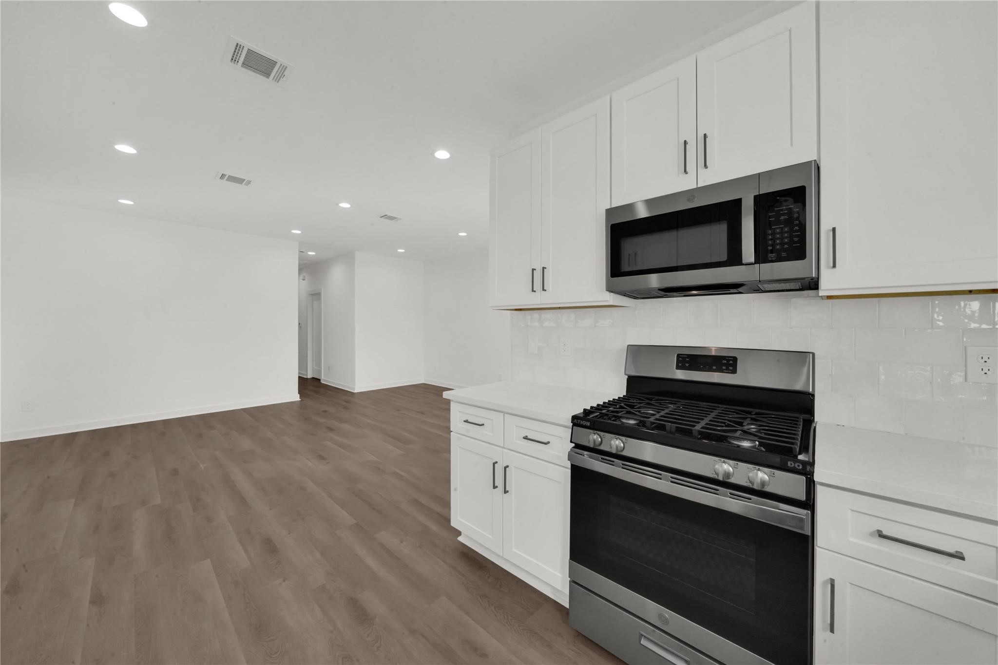 8402 Double, Unit B Houston, TX 77088 - Photo 7 of 21 a kitchen with stainless steel appliances granite countertop a stove microwave and sink