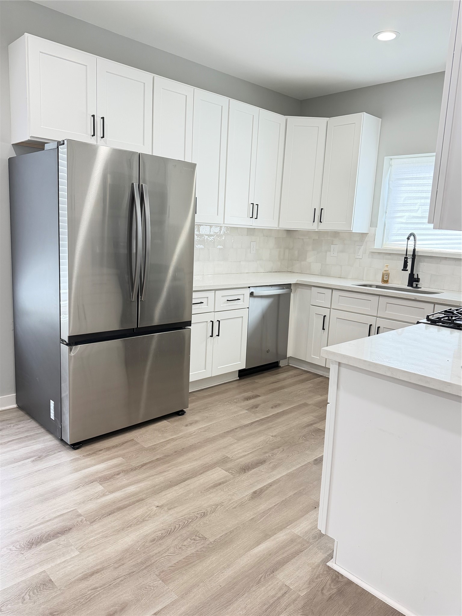 8402 Double, Unit B Houston, TX 77088 - Photo 8 of 21 a kitchen with a refrigerator sink and cabinets