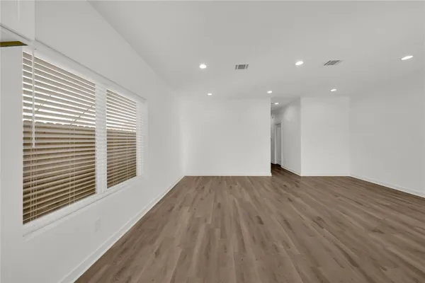 a view of wooden floor and windows in a room