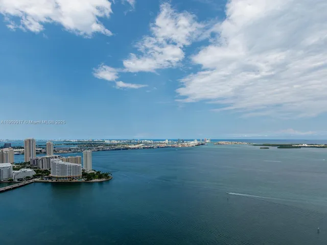 a bathroom with a toilet a sink and a chair