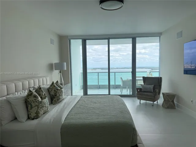 a bedroom with a bed and glass window