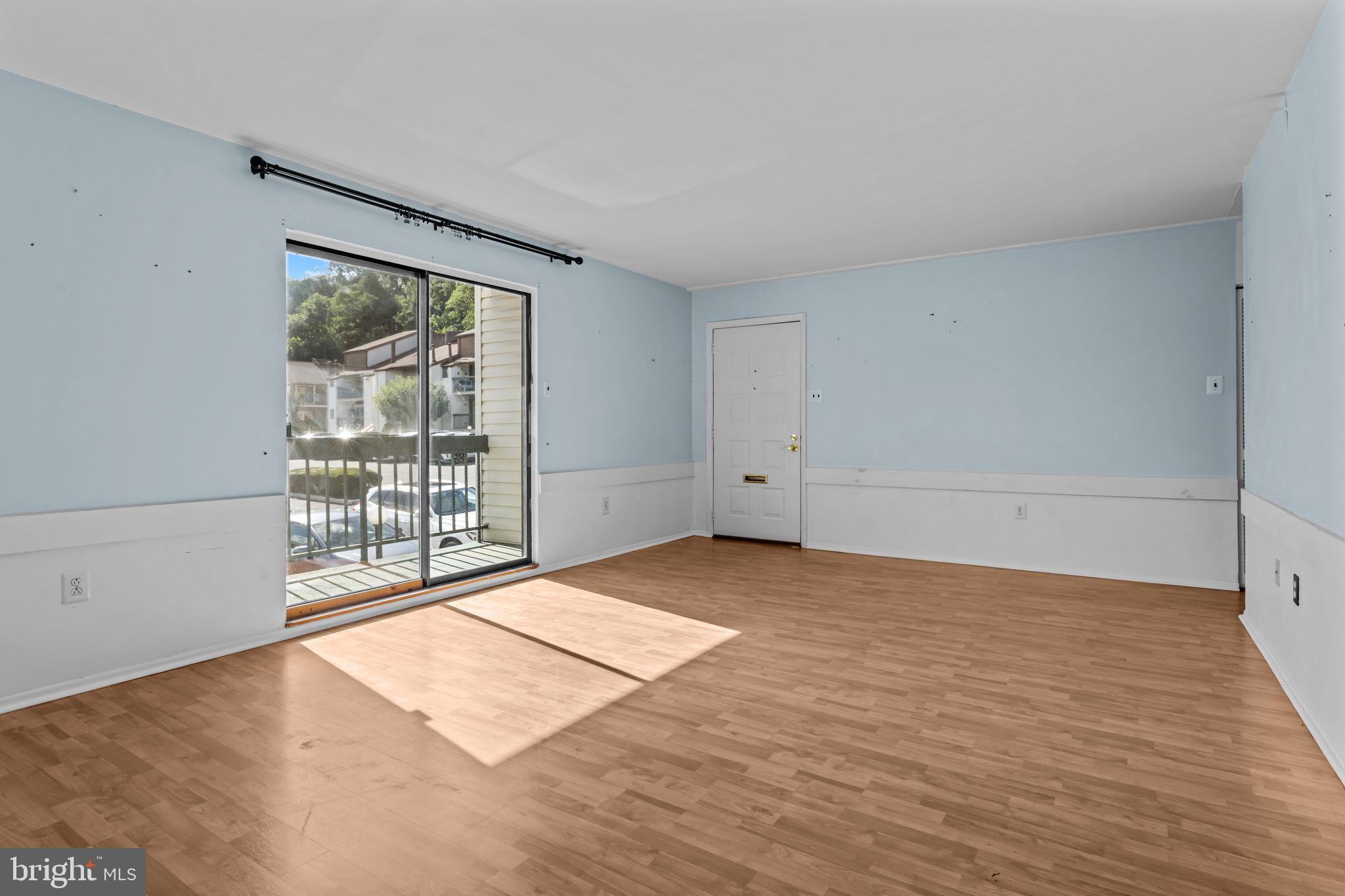 3750 Clarendon Avenue, Unit 3 Philadelphia, PA 19114 - Photo 4 of 20 wooden floor in an empty room with a window