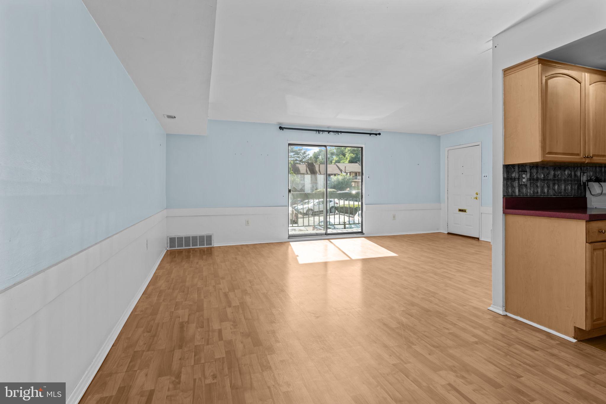 3750 Clarendon Avenue, Unit 3 Philadelphia, PA 19114 - Photo 6 of 20 an empty room with wooden floor and windows