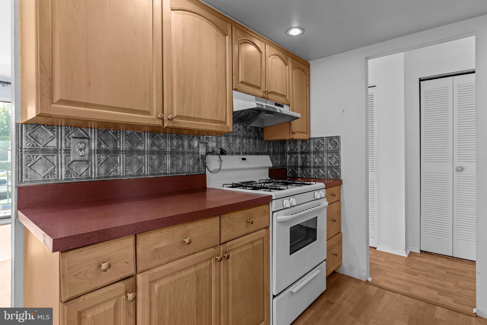3750 Clarendon Avenue, Unit 3 Philadelphia, PA 19114 - Photo 8 of 20 a kitchen with stainless steel appliances granite countertop a stove a sink and a microwave