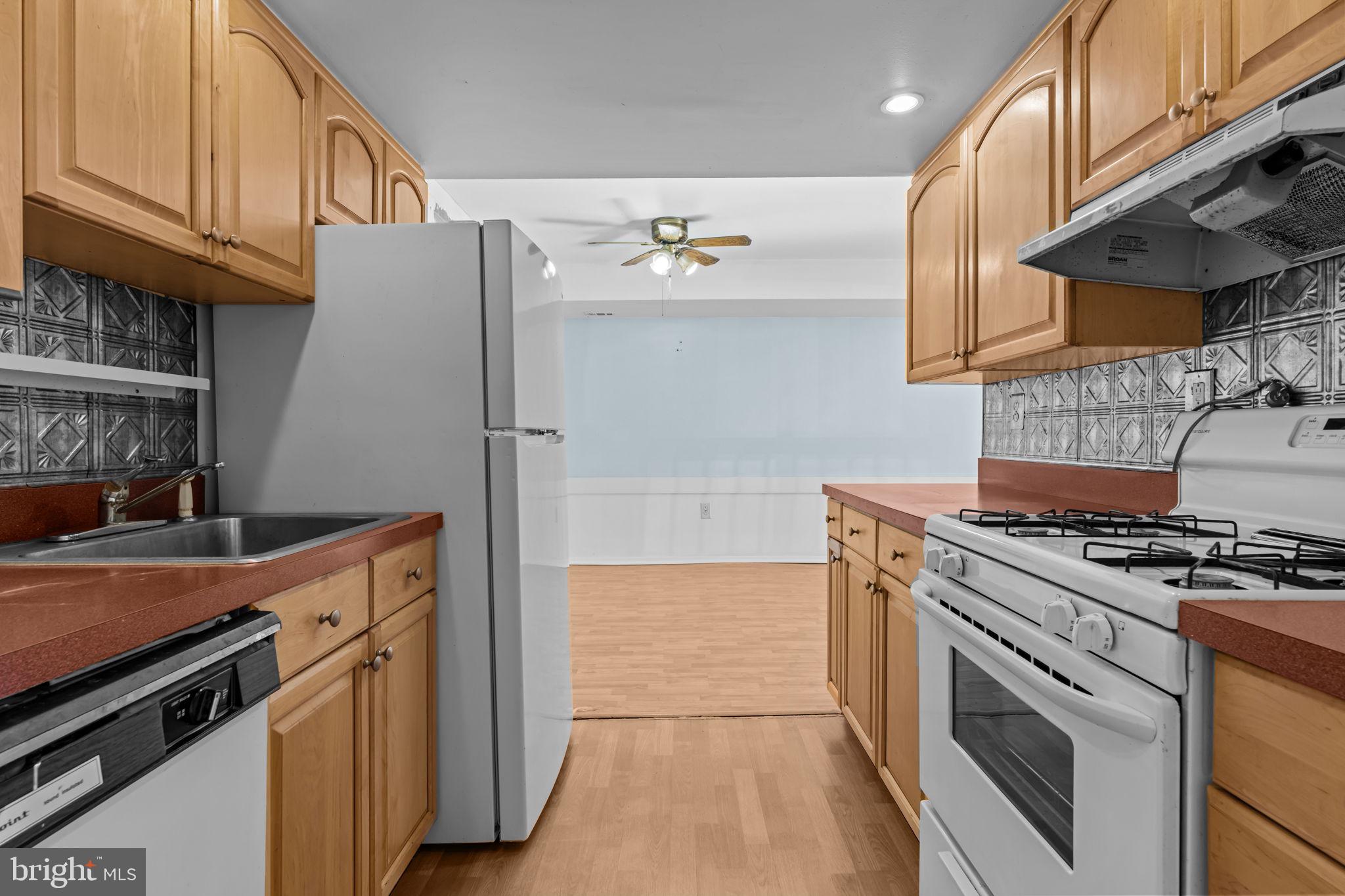 3750 Clarendon Avenue, Unit 3 Philadelphia, PA 19114 - Photo 10 of 20 a kitchen with stainless steel appliances granite countertop a stove and a refrigerator