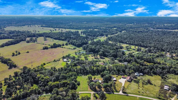 an aerial view of a house with a yard