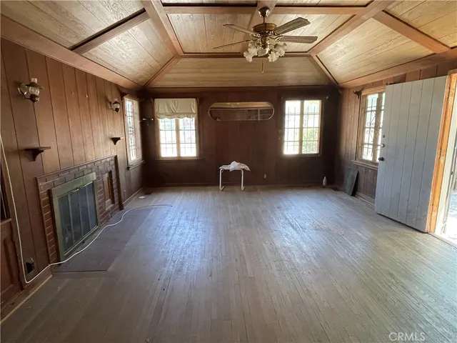 a view of a room with wooden floors and lots of cabinets
