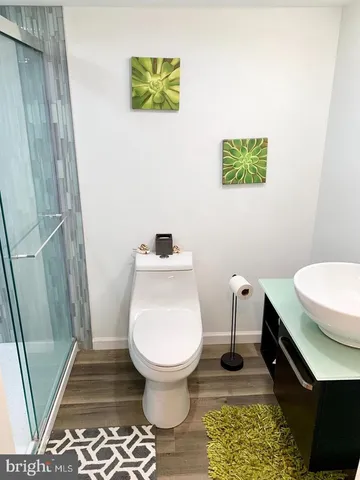 a bathroom with a toilet and a shower