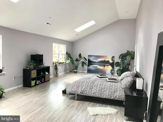 a bedroom with furniture and a flat screen tv