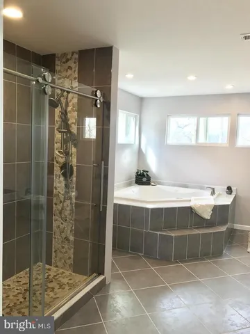 a bathroom with a shower and a mirror
