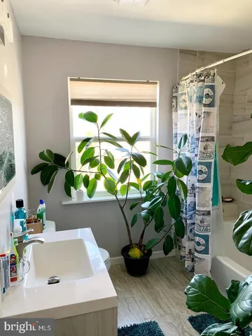 a vase of flowers sitting on a table with a window