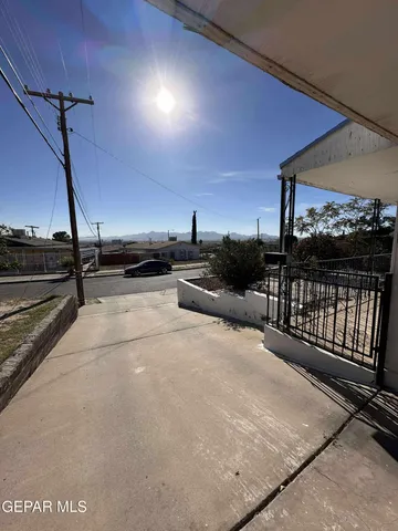 a view of an empty room and a kitchen