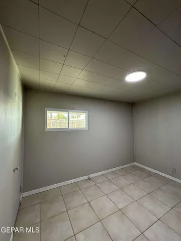 a kitchen with granite countertop cabinets and refrigerator