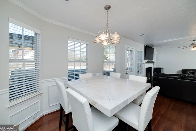 a view of a dining room with furniture window and wooden floor