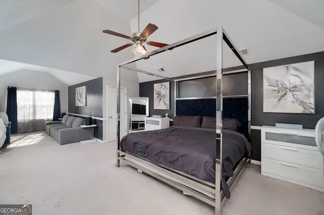 a bedroom with a bed a couch and dresser