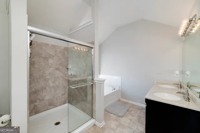 a bathroom with a shower sink and mirror