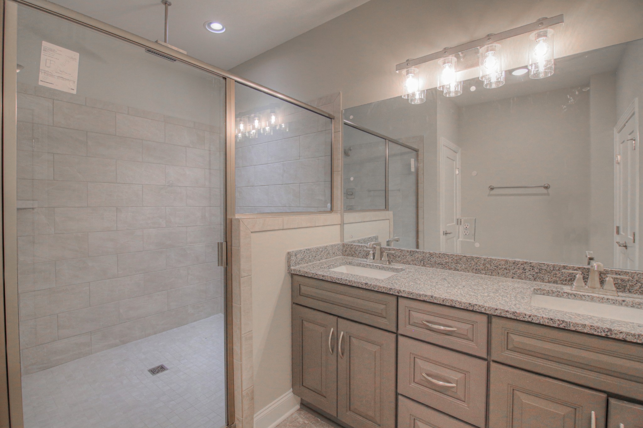 2575 Tracy Road Watertown, TN 37184 - Photo 11 of 23 a bathroom with a granite countertop sink a mirror and shower