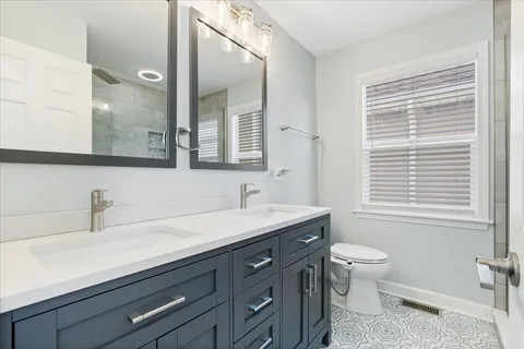 a view of a chair and table in backyard of the house