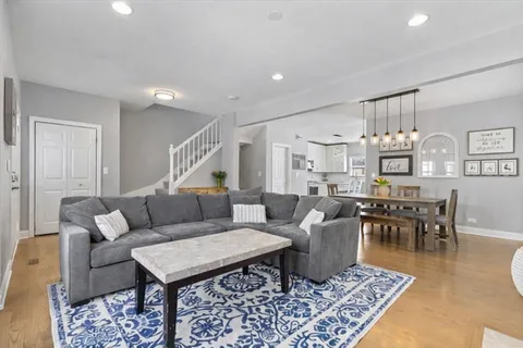 a living room with furniture a rug and a table