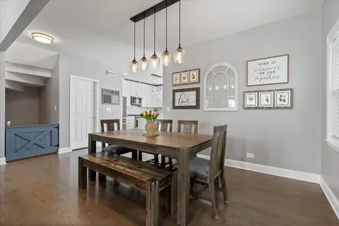 a view of a dining room with furniture and wooden floor
