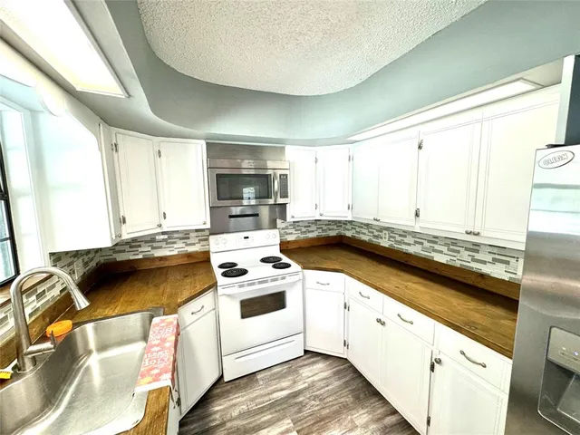 a kitchen with a stove a sink and a microwave