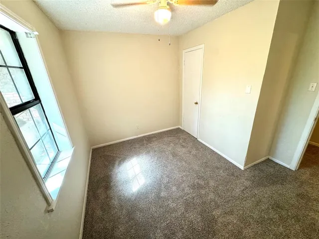 an empty room with windows and entrance