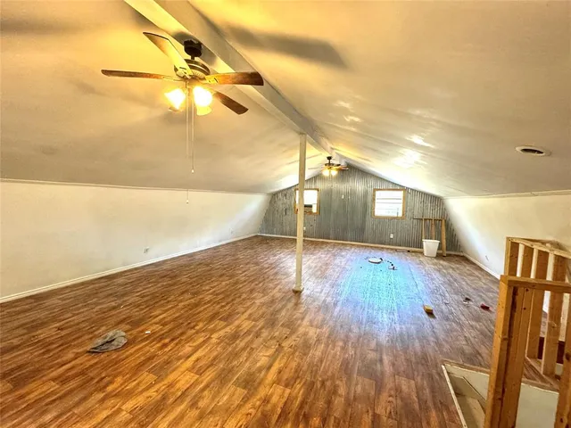 a view of a room with wooden floor