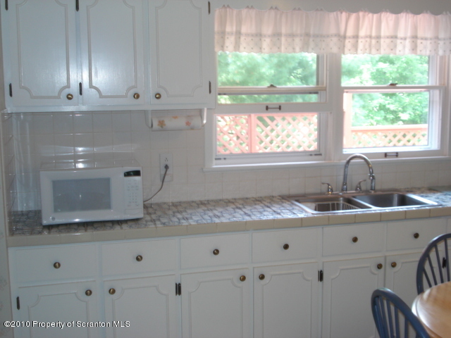 339 Maple Lake Road Moscow, PA 18444 - Photo 4 of 21 a kitchen with granite countertop white cabinets and a sink